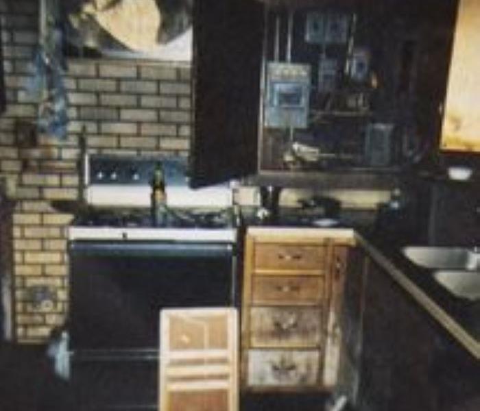 photo of fire damaged basement kitchen, soot and smoke
